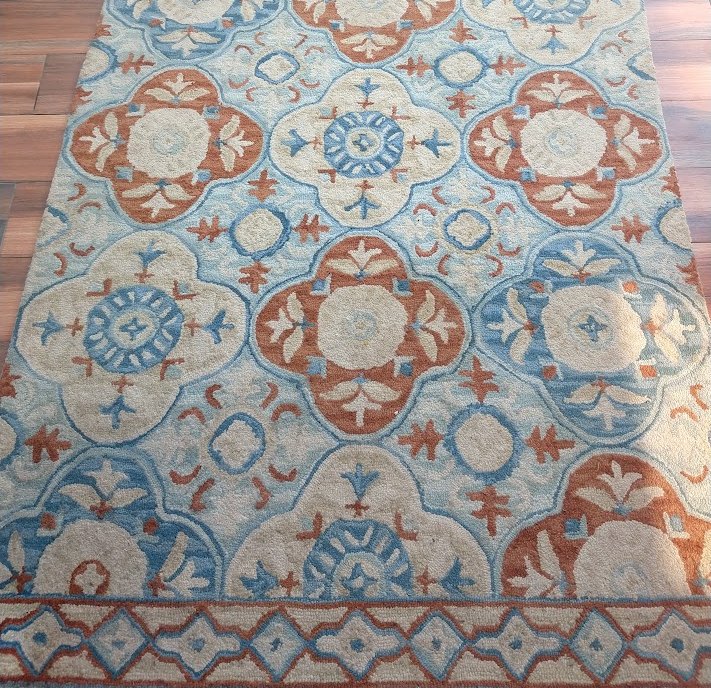Patterned rug, colour revived — before cleaning