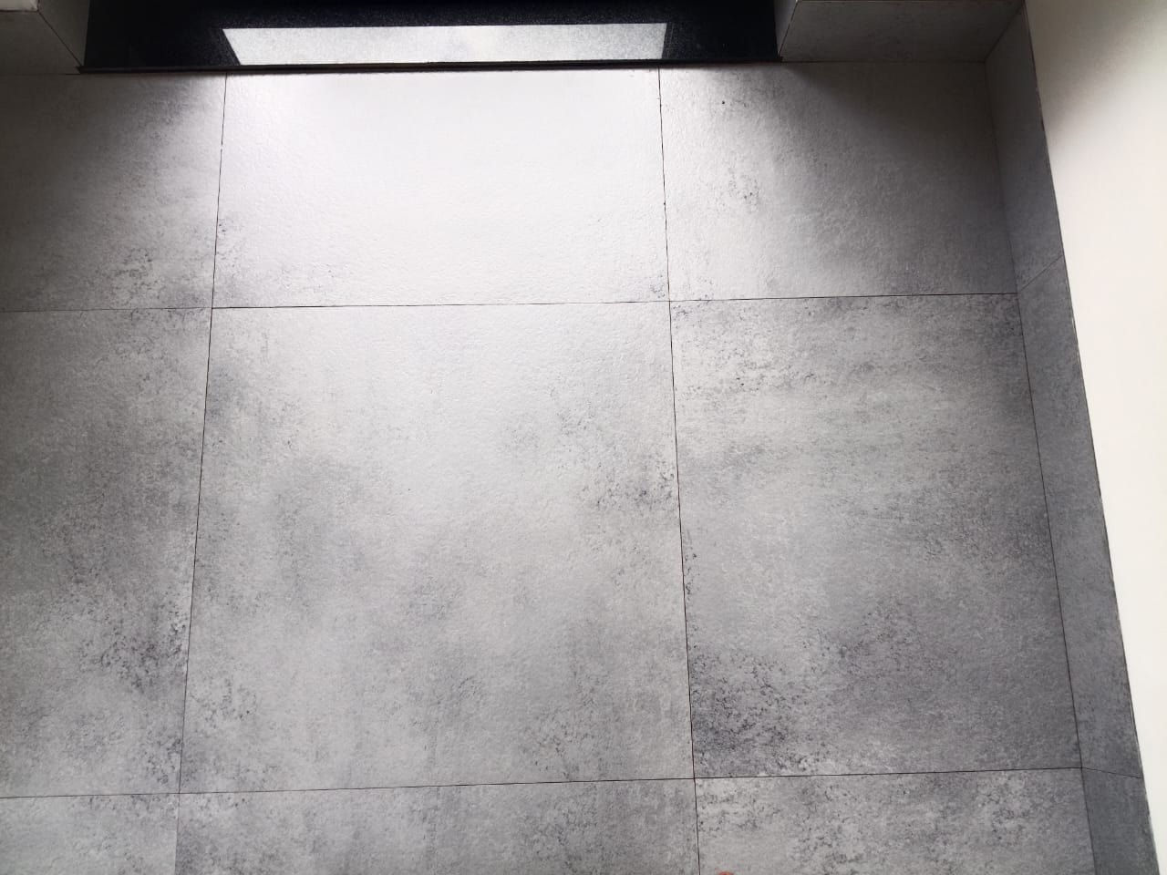Tile floor, cement staining lifted — after cleaning by Filth Fighters