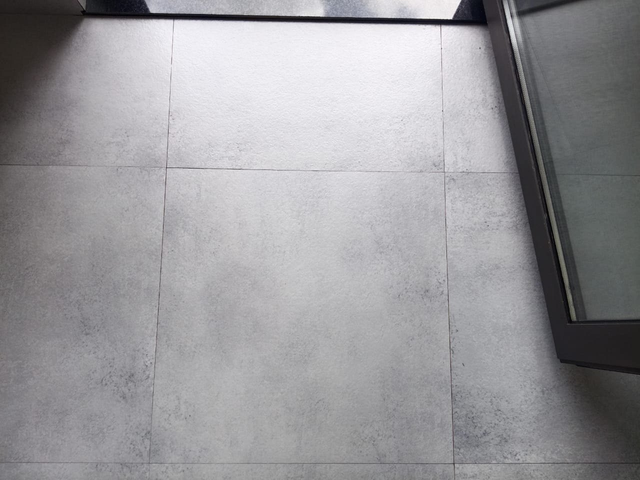 Doorway tiles, cement film cleared — after cleaning by Filth Fighters