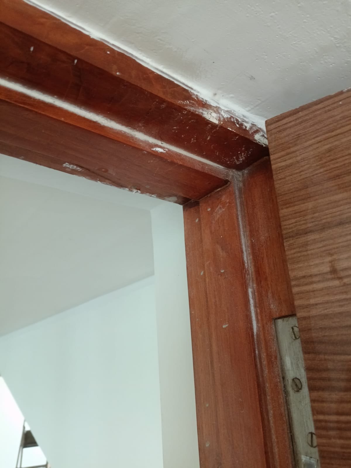 Door frame, paint and plaster off the timber — before cleaning