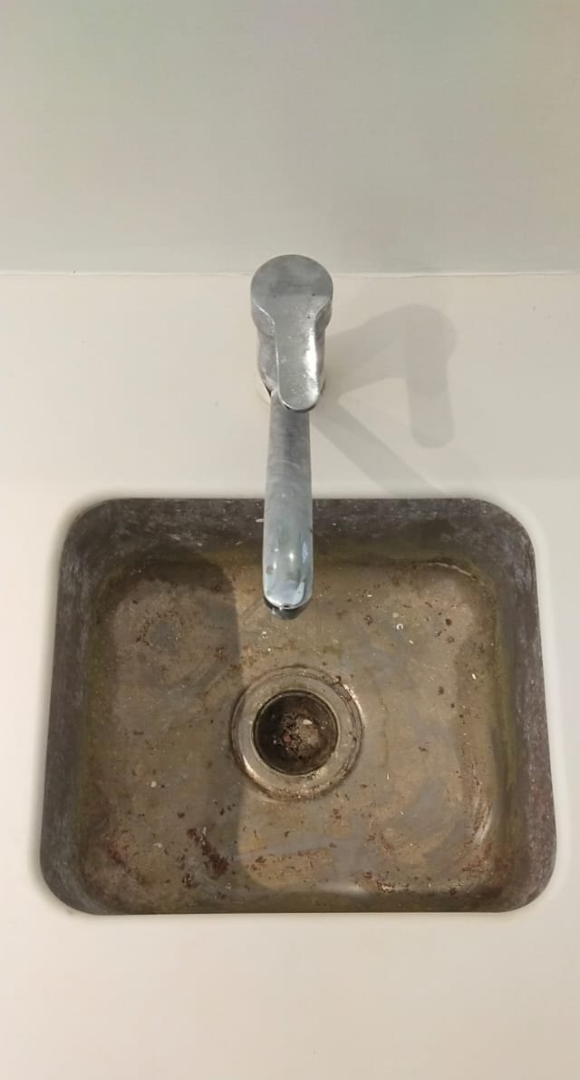 Sink, builders’ residue scoured out — before cleaning
