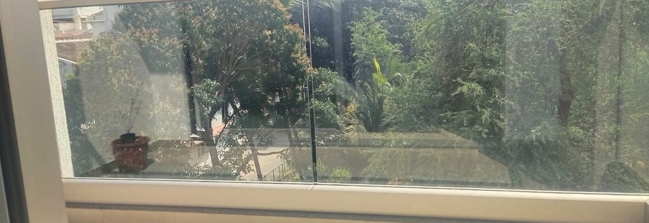 Balcony glass, paint spatter and dust removed — after cleaning by Filth Fighters